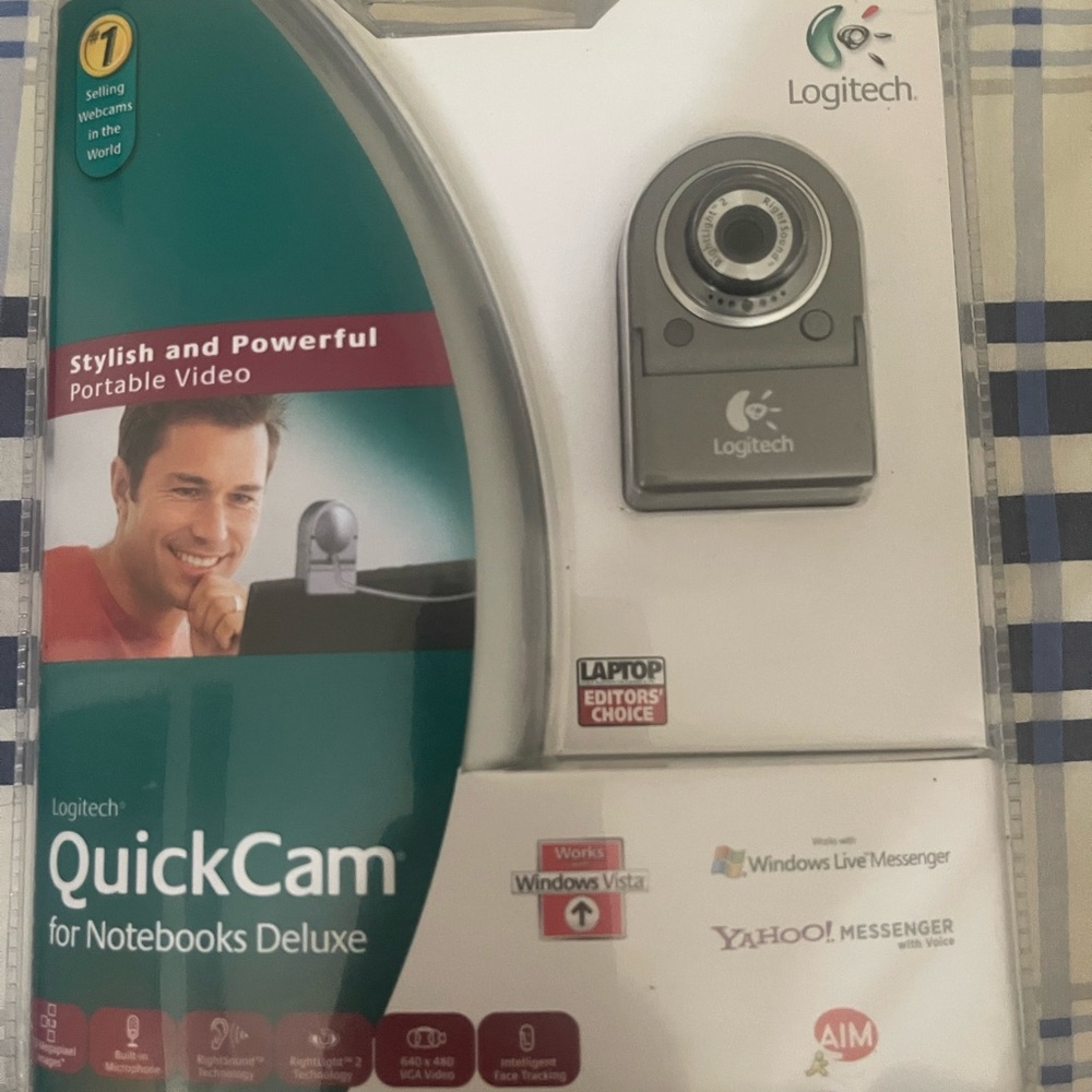 One Logitech quick cam for notebook deluxe camera.